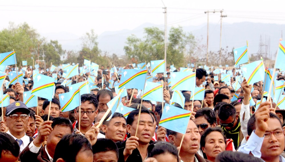 Here’s to our shared future:  A sea of Naga humanity waving the ‘Star and Rainbow’ Naga flag during a historic Naga Reconciliation meeting held at Agri Expo Center, Dimapur on Wednesday. (Photos by Caisii Mao)
